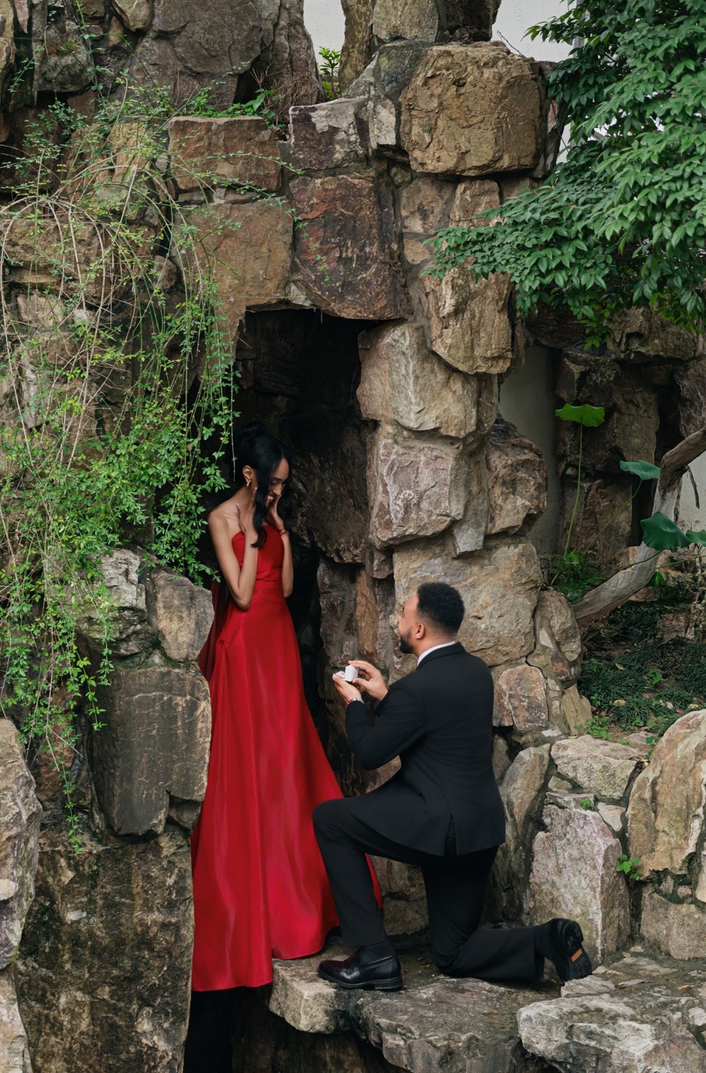 Israel proposing to Lydia in a red dress setting
